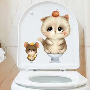 Cute cartoon cat and mouse toilet lid decals on a white ceramic bathroom background