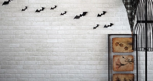 Detailed 3D black PVC bats in various sizes on a white brick wall for Halloween decor