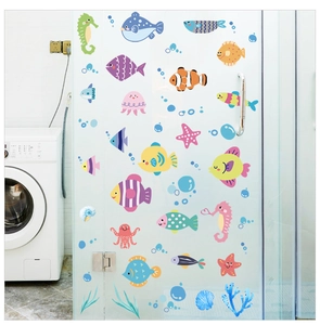 Detailed view of colorful ocean animal wall stickers applied to a glass shower door surface