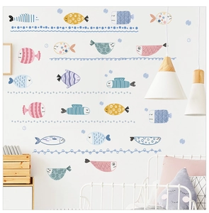 Detailed view of colorful cartoon fish wall stickers in a cozy child bedroom interior