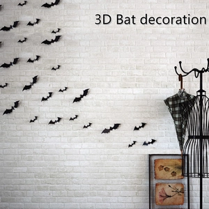 Black 3D bat wall stickers with realistic wings on a white brick wall for Halloween decor