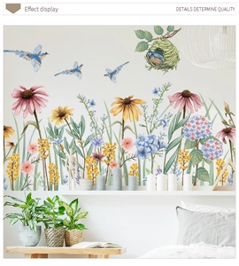 Detail showing watercolor daisies and birds wall sticker on white bedroom wall
