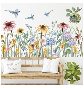 Detail of watercolor floral wall stickers featuring flowers, birds and a bird nest on a wall