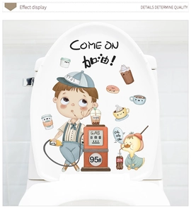 Detail showing cartoon boy and duck toilet seat sticker decals in a bathroom setting
