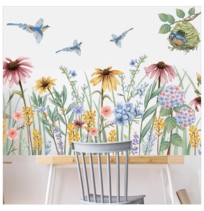 Detail of floral wall stickers with daisies, birds and bird nest in a home office setup