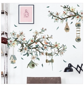Detail of floral wall stickers with white magnolia flowers and hanging bird nests