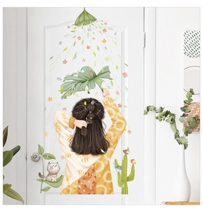 Detail of creative leaf and cartoon girl wall stickers on a white bedroom door