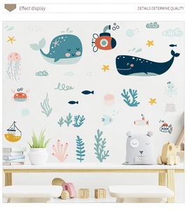 Detail of whale and ocean wall stickers showing soft macaron colors for kids nursery decor