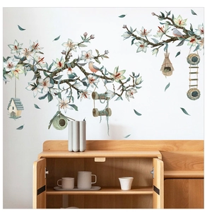 Detail of floral wall decals featuring watercolor magnolias bird nests and hanging cages