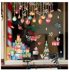 Detail view of watercolor Christmas window stickers with gift boxes and tree motifs