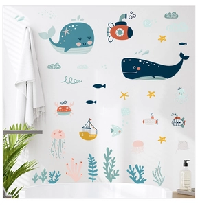 Detail of cartoon whale and ocean wall stickers on bathroom wall with soft lighting