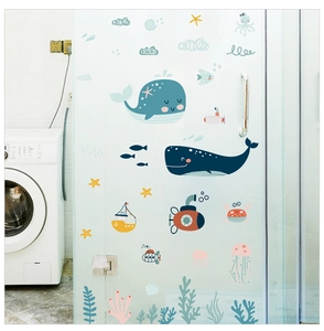 Detail of cartoon whale and ocean creature wall decals applied to a glass sliding door