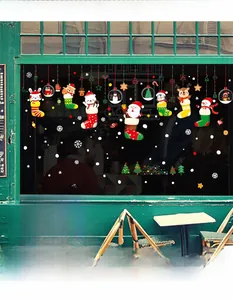 Detail showing colorful cartoon Santa and reindeer static window stickers on glass