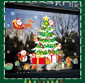 Detailed view of Christmas tree and Santa window stickers on a glass storefront