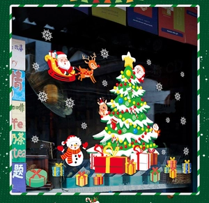 Detail view of colorful Christmas tree and Santa window stickers on glass storefront