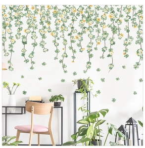 Detail of hanging green vines and clover wall stickers in a modern minimalist bedroom