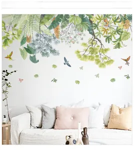 Detail of tropical palm leaves and birds wall sticker on white living room wall