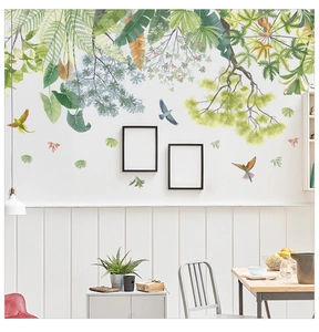 Detail of tropical green leaf wall decals with colorful birds in a Nordic style dining room