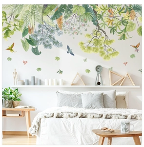 Detail of tropical plant wall stickers with ferns and colorful birds on bedroom wall