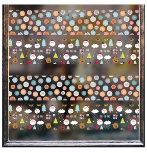 Close-up of Santa Claus and snowman window decals on glass with festive HO HO HO text