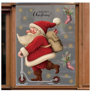 Detail of Christmas window stickers with Santa on a scooter and festive snowflakes