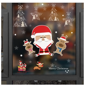 Detail of Christmas window clings featuring Santa, reindeer, and snowflakes on glass