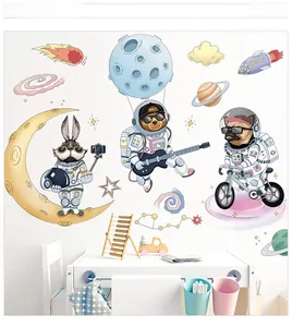 Detail showing space-themed wall decals with astronaut animals on a white bedroom wall