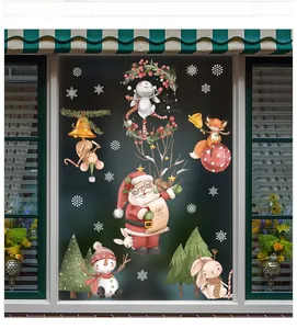 Close-up of Christmas window stickers with cartoon Santa and reindeer on glass display