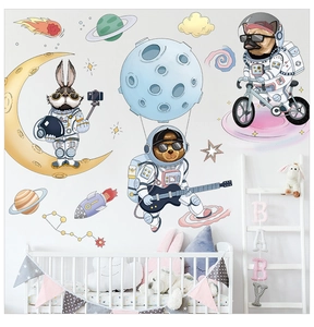 Detailed view of cartoon astronaut animal wall stickers in a cozy nursery bedroom