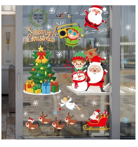 Detail of Christmas window stickers featuring Santa, reindeer, and tree on a glass door