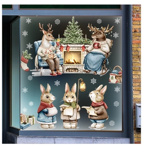 Detail view of festive window stickers with reindeer and bunnies in a cozy winter scene