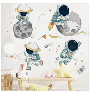 Close-up of cute astronaut wall stickers with planets and stars in a cozy nursery room