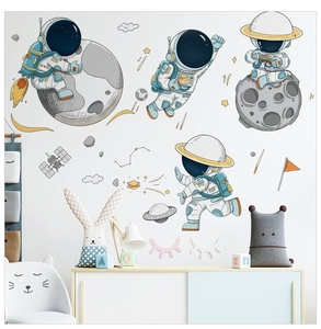 Cartoon astronaut and planet wall stickers applied to a bright children's bedroom wall