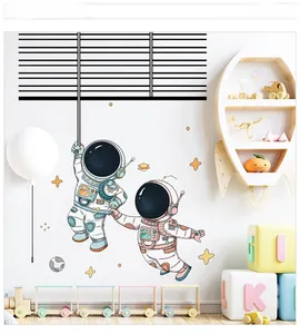 Detailed view of cartoon astronaut wall decals in a bright kid's room setting