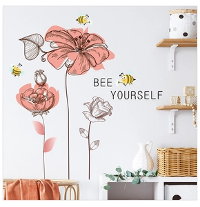 Detail of floral wall decals with bees and Bee Yourself text on white bedroom wall