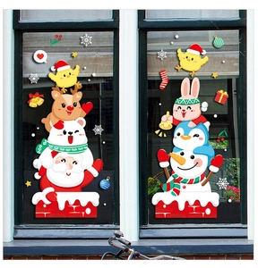 Detail of Santa and Snowman static window decals applied on a glass storefront surface