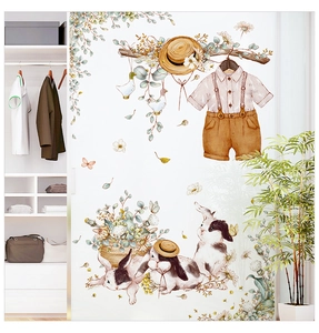 Detail of watercolor rabbit wall stickers on a white closet in a cozy child bedroom