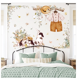 Nursery wall stickers showing watercolor rabbits and plants on a white bedroom wall