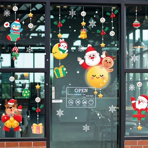 Christmas window decals with Santa Claus, reindeer and snowflakes on glass storefront