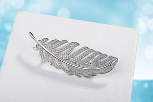 Macro view of feather brooch with zircon stones on silver-tone metal base