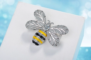 Macro shot of bee brooch featuring micro-set zircon wings and yellow enamel body detail