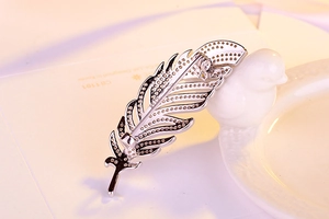 Detailed macro view of S925 sterling silver feather brooch back with secure pin clasp