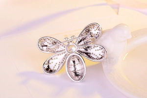 Detailed back view of a silver bee brooch showing the secure pin and rotating safety clasp