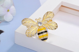 Detailed view of bee brooch with gold plating, cubic zirconia wings and enamel body