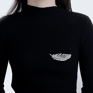 Silver feather brooch with zircon stones on a black sweater for women fashion