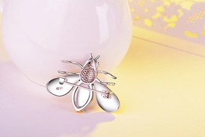 Macro detail of S925 sterling silver stamp on bee brooch back with needle clasp
