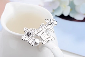 Detail of S925 sterling silver butterfly brooch with zircon pavé and white pearls