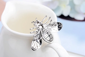Macro shot of silver bee brooch back showing S925 hallmark and pin clasp detail