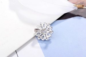 Detailed back view of S925 silver flower brooch showing zircon inlay and clasp