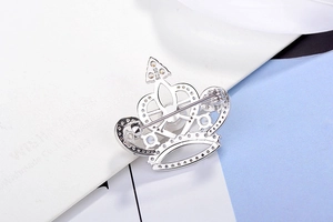 Close-up of the crown brooch reverse side showing the S925 silver hallmark and safety pin clasp